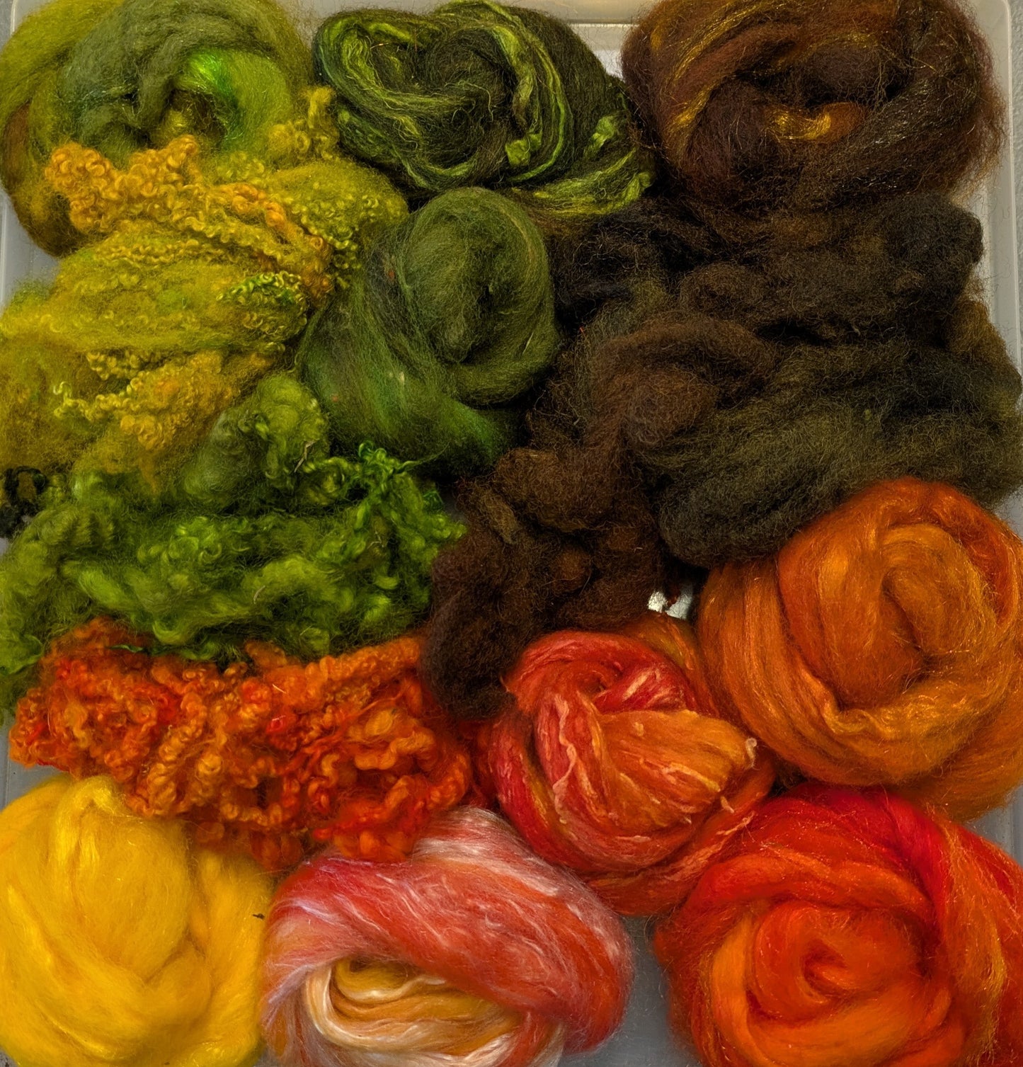 Hand dyed wool mix top with added texture and hand dyed fleece. Great to needle felt or wet felt 140g Autumn 1