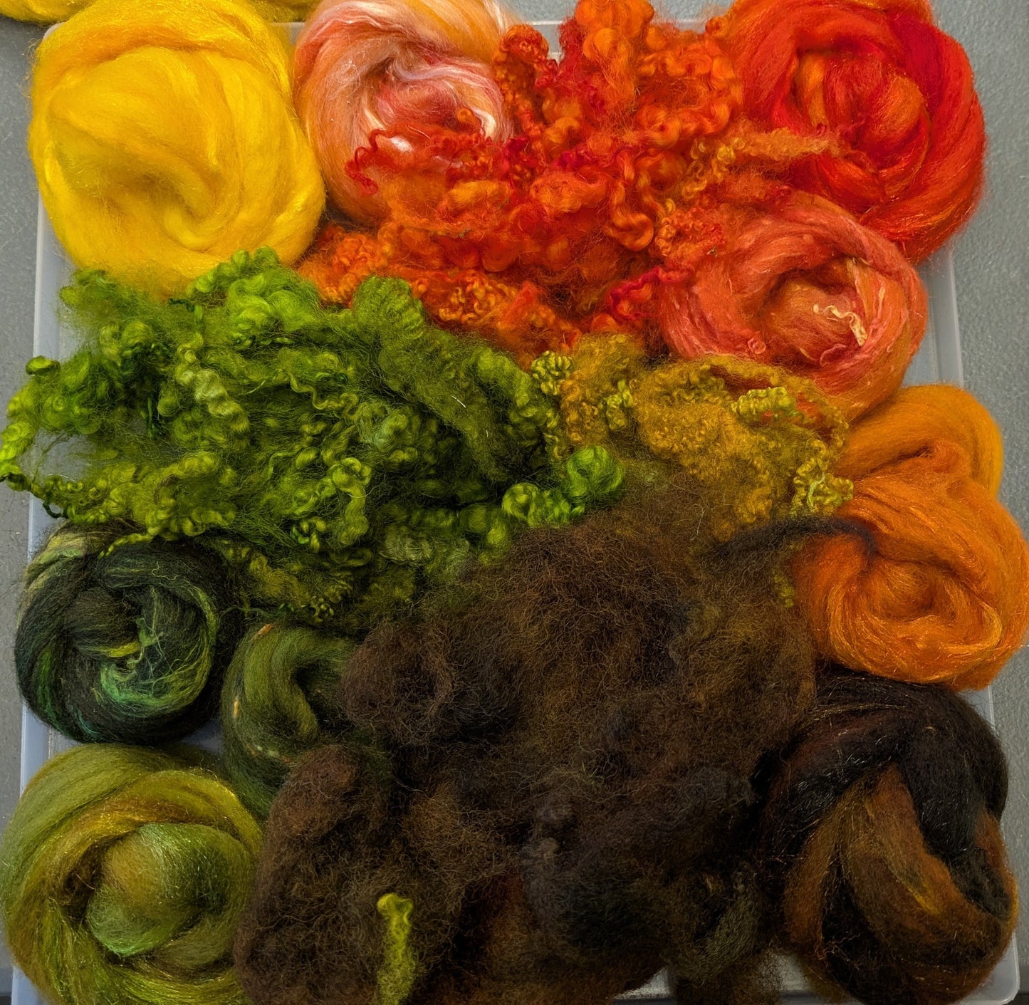 Hand dyed wool mix top with added texture and hand dyed fleece. Great to needle felt or wet felt 140g Autumn 3